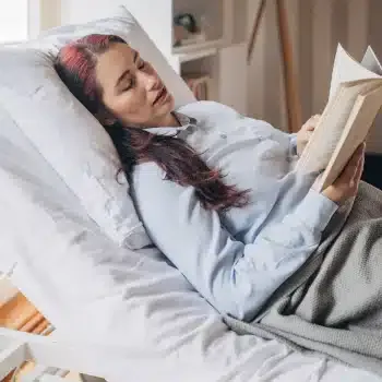 A woman reading in an adjustable hospital bed